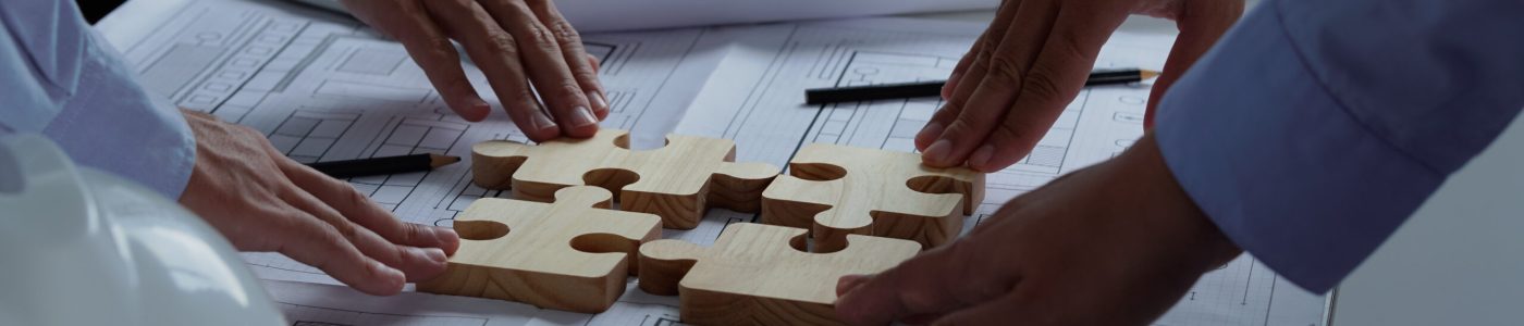 Teamwork and partnership concept. Business solutions, success and strategy concept. Hands connecting puzzle. Hand of the team fold puzzle, closeup. Teamwork and partnership concept. Business solutions, success and strategy concept. Hands connecting puzzle. Hand of the team fold puzzle, closeup.